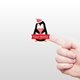 A hand holding a small personalised Christmas sticker featuring a penguin wearing a Santa hat. The penguin holds a red heart and has a red banner below it with the text 