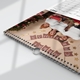 Close-up of a wire-bound personalised A3 calendar featuring a family Christmas photograph and 2027 grid.