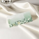 wedding place card in elegant design printed on folded white cardstock ready for you to write your names. Set on a softly draped ivory tablecloth, creating a sophisticated and timeless look.