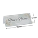 Personalised wedding place card with your name in elegant design on folded white cardstock. Dimensions are 90mm wide by 37mm high, shown with measurement indicators on a plain white background.