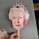a 350gsm card face mask of Queen Elizabeth II showing the stick to hold up the face mask.